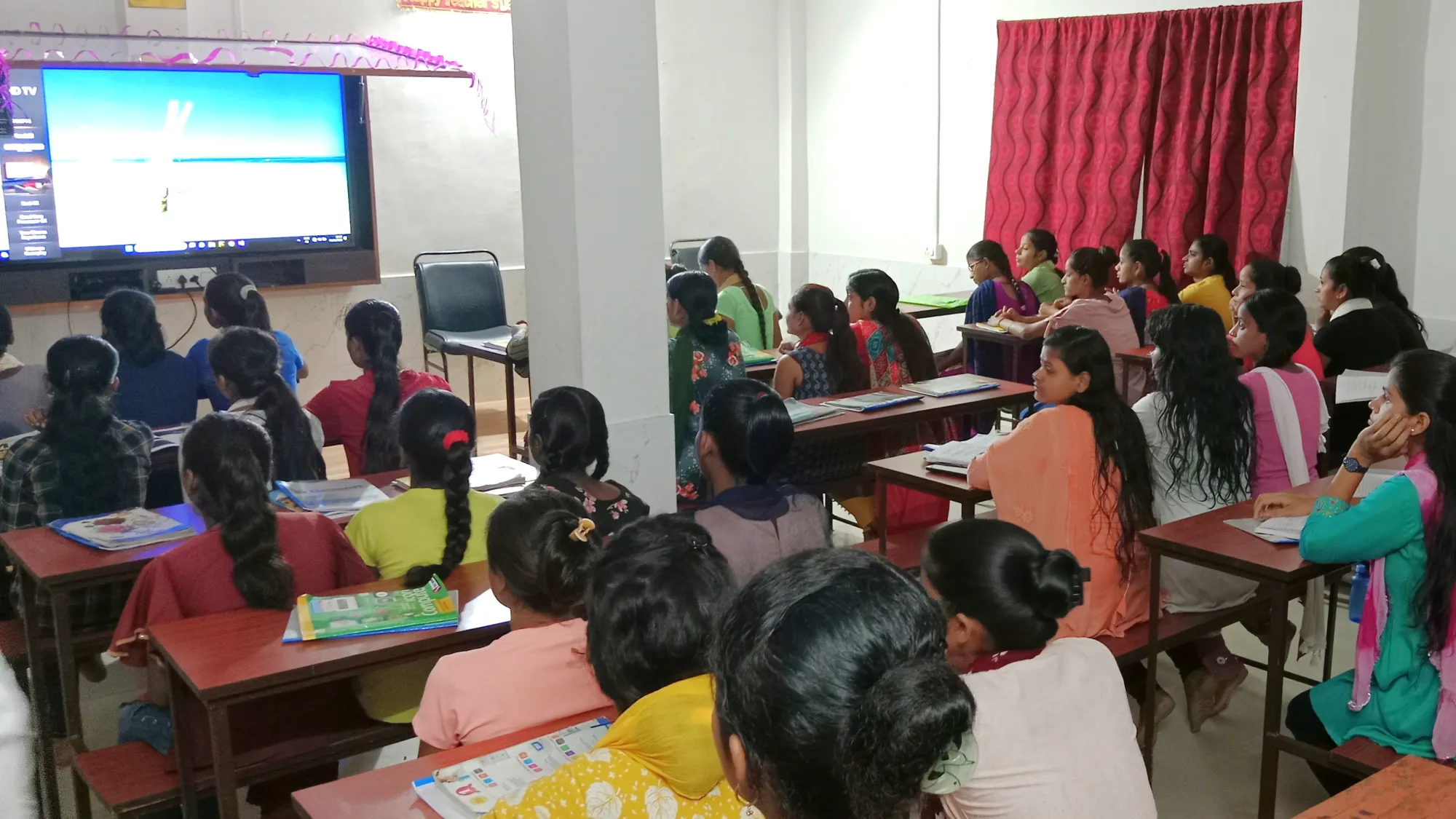 Students studying in class with digital board